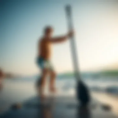 Adjusting Paddle Length for Comfort and Efficiency A paddleboarder adjusting paddle length on a beach