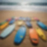 A vibrant collection of top bodyboards displayed on a sandy beach.