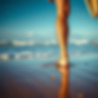 Surfer in Flip Flops on the Shoreline A surfer walking on the beach wearing flip flops