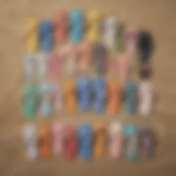 Variety of beach flip flops displayed on sand