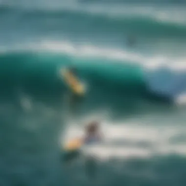 An aerial view of surfers riding waves on stand up paddle boards