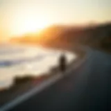 A serene longboard cruising scene along a coastal road