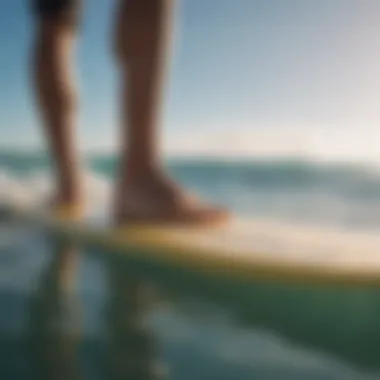 Close-up of a surfer's feet on a surfboard in the ocean