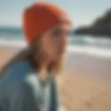 A fashionable surfer wearing a beanie on the beach