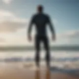 Surfer wearing surf waders on a beach