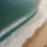 Aerial view of a pristine surf beach with perfect waves