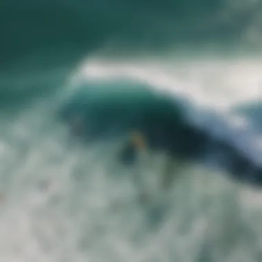 An aerial view of surfers in the water, capturing the dynamic movement of waves