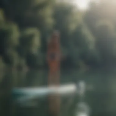 Short individual enjoying paddle boarding on a calm lake