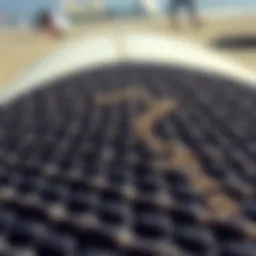 Close-up view of a textured surfboard deck pad showcasing its grip features.