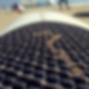 Close-up view of a textured surfboard deck pad showcasing its grip features.