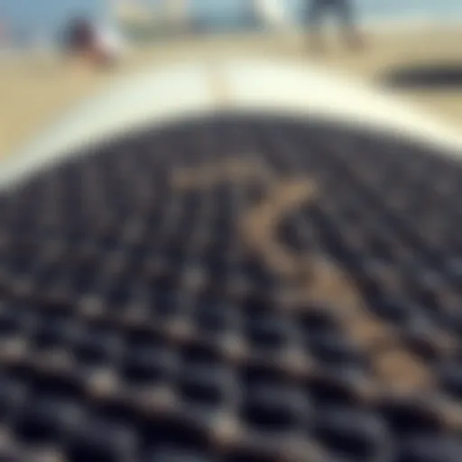 Close-up view of a textured surfboard deck pad showcasing its grip features.