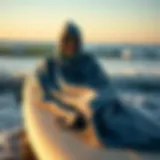 Stylish towelling poncho draped on a surfboard