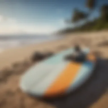 A surfboard and swim fins resting on the beach